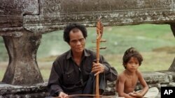 A blind musician plays his traditional Cambodian violin along the promenade at Angkor Wat in Siem Reap on Monday January 22,1996. (AP Photo/Richard Vogel)