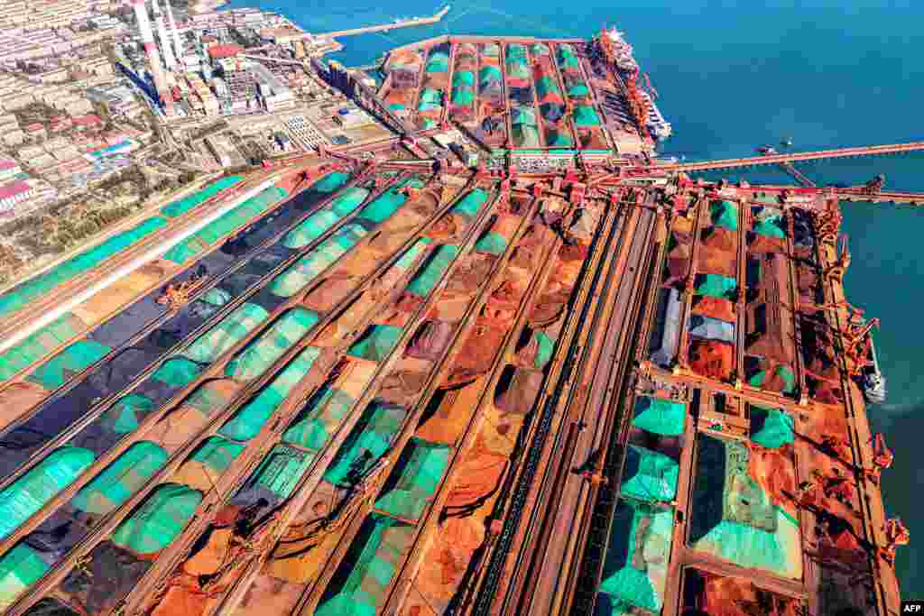 An aerial view shows imported iron ore piled up at a port in Qingdao, in China's eastern Shandong province.
