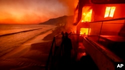 洛杉磯馬利布地區的消防員正在努力撲救一棟燃燒的海濱建築。 (2025年1月8日)