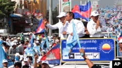 Opposition party Cambodia National Rescue Party (CNRP) President Kem Sokha greets his supporters from a truck as he leads a rally during the last day of campaigning ahead of communal elections in Phnom Penh, Cambodia, Friday, June 2, 2017.