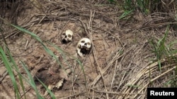 FILE - Human skulls suspected to belong to victims of a recent combat between government army and Kamuina Nsapu militia are seen on the roadside in Tshienke near Kananga, the capital of Kasai-central province of the Democratic Republic of Congo, March 12, 2017. 
