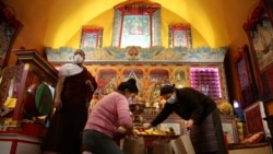Lama Gelbu, Pasang Sherpa and Yanddu Lama, prepare bags of fruit used as ceremonial offerings at the United Sherpa Association in Queens, New York, on Friday, January 8, 2021. (AP Photo/Jessie Wardarski)