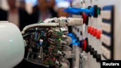 A humanoid robot operates a switchboard during a demonstration by the German research centre for artificial intelligence, Hanover, Germany. March, 5, 2013. REUTERS/Fabrizio Bensch