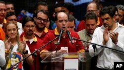 Venezuelan lawmaker and President of National Assembly, Julio Borges, center, speaks after the announcement of results of a symbolic referendum in Caracas, Venezuela, Sunday, July 16, 2017. Venezuelan's opposition said more than 7.1 million people responded to its call to vote Sunday in a symbolic rejection of President Nicolas Maduro's plan to rewrite the constitution, a proposal that has raised tensions in a nation suffering through widespread shortages and months of anti-government protests. (AP Photo/Ariana Cubillos)