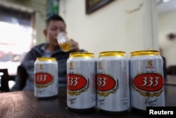 FILE - A man drinks Sabeco's 333 beer at a restaurant in Hanoi, Vietnam, Dec. 18, 2017.