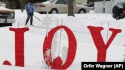A resident digs out from a holiday snow storm on December 25, 2009, in Lawrence, Kansas. (AP Photo/Orlin Wagner, File)