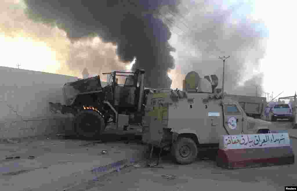Damaged vehicles belonging to Iraqi security forces are seen during clashes between Iraqi security forces and al-Qaida-linked Islamic State in Iraq and the Levant in Mosul, Iraq, June 10, 2014. 