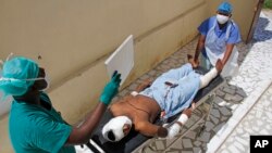 Medical workers attend to a man injured in a mortar shell attack, at Medina hospital during Somali Independence day ceremony in Mogadishu, Somalia, July 1, 2018. 