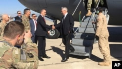 U.S. Secretary of Defense Jim Mattis, center, is greeted by U.S. Ambassador Douglas Silliman as he arrives at Baghdad International Airport on an unannounced trip, Feb. 20, 2017.