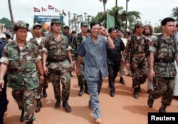 Cambodian Prime Minister Hun Sen, pictured here with his bodyguards in 1997, is one of the world’s longest serving leaders. REUTERS/Stringer