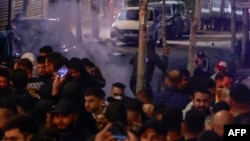People clash with Palestinian security forces during a rally in solidarity with the Palestinians of the Gaza Strip in the West Bank city of Ramallah, on October 17, 2023.
