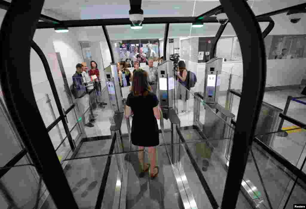 A passenger enters an airlock for facial recognition at Nice international airport's immigration section in Nice, France.