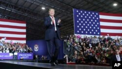 President Donald Trump walks toward the podium to speak at a rally at Total Sports Park, April 28, 2018, in Washington, Mich.