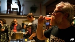 In this photo taken on Saturday, Feb. 23, 2019, brewer Sigurdur Snorrason drinks a craft beer at a festival in Reykjavik. On Friday, March 1 the country toasts the anniversary of the lifting of a decades-long ban on beer. (AP Photo/Egill Bjarnason)