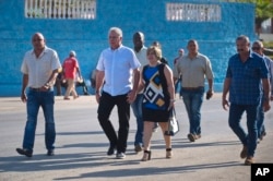 Cuba's Vice President Miguel Diaz-Canel and his wife Lis Cuesta Peraza walk, surrounded by security, to a voting center during elections for national and provincial representatives for the National Assembly in Santa Clara, Cuba, Sunday, March 11, 2018. (AP Photo)