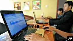 Young Cambodians are surfing the internet at a local cafe shop in Phnom Penh. 