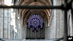 FILE - Pipes of Notre Dame cathedral's organ are seen during preliminary restauration work, in Paris, France, July 17, 2019. 