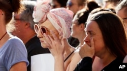 People attend a vigil in Albert Square, Manchester, England, May 23, 2017, the day after the suicide attack at an Ariana Grande concert that left 22 people dead as it ended on Monday night.