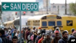 Central American migrants line up for a meal at a shelter in Tijuana, Mexico, Nov. 14, 2018.