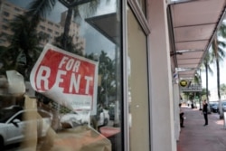 FILE - In this July 13, 2020 file photo, a For Rent sign hangs on a closed shop during the coronavirus pandemic in Miami Beach, Fla.