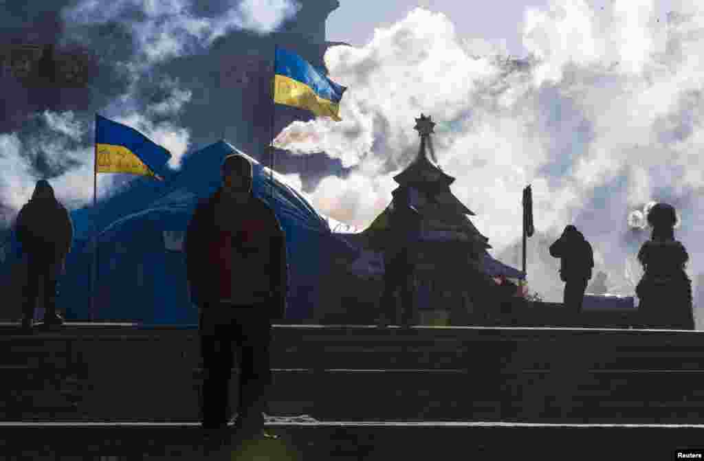 Anti-government protesters walk in the tent city at Independence Square in Kyiv, Jan. 30, 2014.