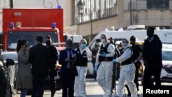 Police officers secure the area where an attacker stabbed a female police administrative worker, in Rambouillet, near Paris, France, April 23, 2021. 