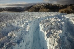 FILE - A large crevasse forms near the calving front of the Helheim glacier near Tasiilaq, Greenland, June 22, 2018.
