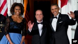 First lady Michelle Obama, left, and President Barack Obama welcome French President François Hollande for a State Dinner at the North Portico of the White House on Tuesday, Feb. 11, 2014.