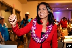 FILE - In this Nov. 6, 2018, file photo, Rep. Tulsi Gabbard, D-Hawaii, greets supporters in Honolulu. Gabbard has announced she’s running for president in 2020.