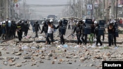 រូបឯកសារ៖ កម្មករ​ត្រូវ​បាន​ចាប់ឃុំ​ខ្លួន​ដោយ​នគរបាល​បង្ក្រាប​កុបកម្ម ក្រោយពី​មាន​ការប៉ះទង្គិច​គ្នា​នៅក្នុង​បាតុកម្ម​មួយ​ក្នុង​ទីក្រុង​ភ្នំពេញ នៅ​ថ្ងៃទី៣ ខែមករា ឆ្នាំ២០១៤។ (រូបថត៖ Reuters)