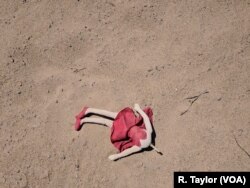 An abandoned doll lay on the sand in San Luis, Arizona, less than a hundred meters from the U.S.-Mexico barrier.