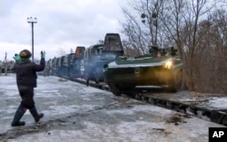 Na ovoj fotografiji preuzetoj sa video snimka koji je dostavila služba za štampu ruskog ministarstva odbrane, rusko oklopno vozilo silazi sa željezničke platforme u Bjelorusiji, 19. januara 2022.