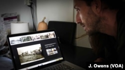 Adonis playing a video depicting the events of 1922 that led to the death of thousands of Greeks in Smyrna, now called Izmir in modern-day Turkey. His grandparents fled the city for Athens.