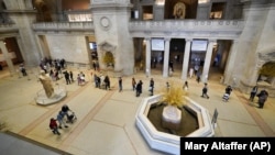 Visitors to the Metropolitan Museum of Art stand in line to purchase tickets, Thursday, April 29, 2021, in New York. (AP Photo/Mary Altaffer)