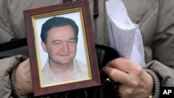 FILE - A portrait of lawyer Sergei Magnitsky, who died in jail.