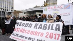 Members of Congolese associations calling on Joseph Kabila to step down as president of the Democratic Republic of the Congo take part in a demonstration in Brussels, Dec. 30, 2017.