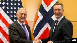 FILE - U.S. Secretary for Defense Jim Mattis, shakes hands with Norway's Defense Minister Frank Bakke-Jensen prior to a meeting on the sidelines of a NATO defense ministers meeting at NATO headquarters in Brussels on Wednesday, Nov. 8, 2017.