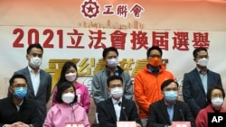 Members of pro-Beijing Hong Kong Federation of Trade Unions, including Stanley Ng Chau-pei, center in front, attend a press conference after winning the Legislative election in Hong Kong, Dec. 20, 2021. 