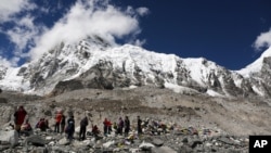 In this 2015 file photo, hikers rest at Mount Everest Base Camp in Nepal. Many goals, like climbing a mountain, require hard work, planning and many small steps to achieve. (AP Photo/Tashi Sherpa, file)