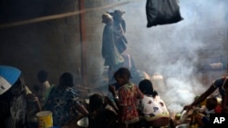 Muslim refugees prepare food at the Catholic church in Carnot, Central African Republic, April 15, 2014.