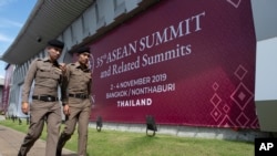 In this Tuesday, Oct. 29, 2019. Thai policemen walk in front of a banner welcoming Association of Southeast Asian Nations at the venue of The 35th annual Association of Southeast Asian Nations (ASEAN) in Nonthaburi province, Thailand. U.S. national…