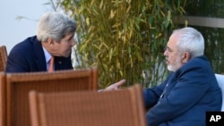 FILE - U.S. Secretary of State John Kerry, left, talks with Iranian Foreign Minister Mohammad Javad Zarif, in Geneva, Switzerland, May 30, 2015. 