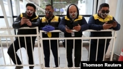 Taxi drivers wait for customers during a general quarantine amid the spread of COVID-19, at the domestic flights arrival area of Arturo Merino Benitez International Airport, in Santiago, Chile, May 27, 2020.