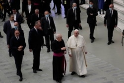 Pope Francis walks towards faithful at the end of his weekly general audience in the Paul VI Hall, at the Vatican, Wednesday, Dec. 22, 2021.