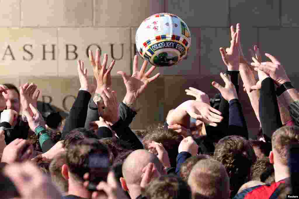 Players from the Up'ards and Down'ards teams compete for the ball during the annual Royal Shrovetide football match in Ashbourne, Britain.