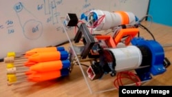 The robot contains eight orange spear tips, two small boxes just behind the carousel containing cameras, the electronics chamber behind the right camera, and a buoyancy chamber behind the left camera. (Worcester Polytechnic Institute)