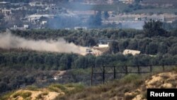 Izraelski tenk manevrira u Gazi, gledano iz južnog Izraela