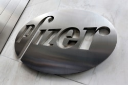 FILE - The Pfizer company logo is seen at the company's headquarters in New York, Dec. 4, 2017.