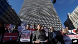 Immigration advocates rally, Nov. 21, 2017, in front of the Jacob J. Javits Federal Building in New York to protest the decision from the Department of Homeland Security to terminate Temporary Protected Status for people from Haiti. 