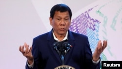 FILE - Philippines' President Rodrigo Duterte gestures during a news conference at the Association of South East Asian Nations (ASEAN) summit in Pasay, metro Manila, Philippines, Nov. 14, 2017.